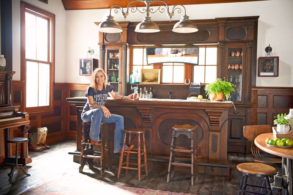 <p>When the barn was in the design stage, Sheryl planned to have a simple writing room upstairs, but once the room was soundproofed, it became a full-blown studio. "It's ideal because I'm a single mom—I can go to work just down the driveway," she says. Downstairs, Sheryl created a saloon and filled the walls with her impressive collection of antique signs. "It's a great gathering place. We've had a lot of really good fund-raising events here," she says.</p>