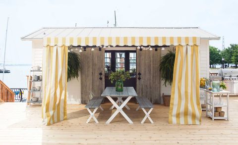wood shed with yellow and white awning in outdoor kitchen ideas