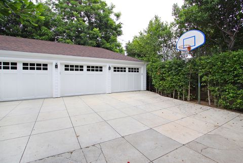 Property, Basketball hoop, Tree, Floor, Road surface, Real estate, Basketball court, Concrete, Signage, Composite material, 