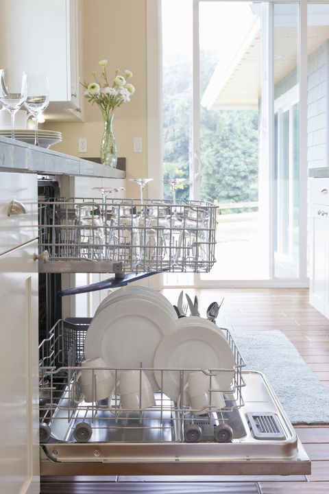 Clean dishes in dishwasher in modern, bright home kitchen