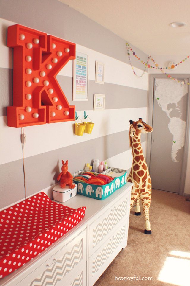 Giraffe, Giraffidae, Floor, Room, Interior design, Flooring, Wall, Orange, Terrestrial animal, Interior design, 