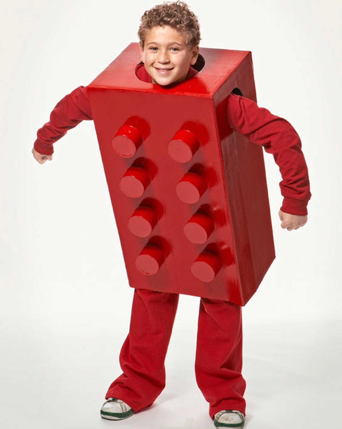 boy wearing red pants, red long sleeved shirt, and giant homemade red lego box costume