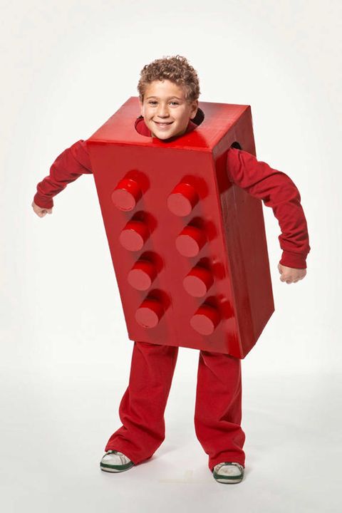 boy wearing red pants, red long sleeved shirt, and giant homemade red lego box costume