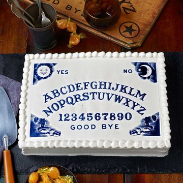 white cake with an ouija board design printed on it