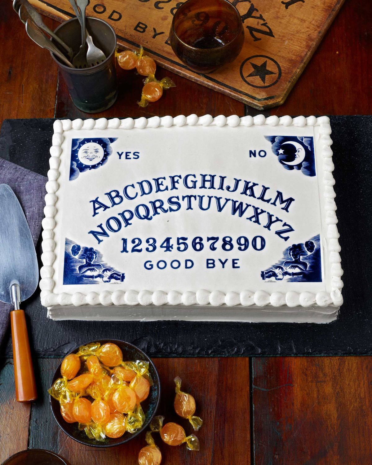 white cake with an ouija board design printed on it