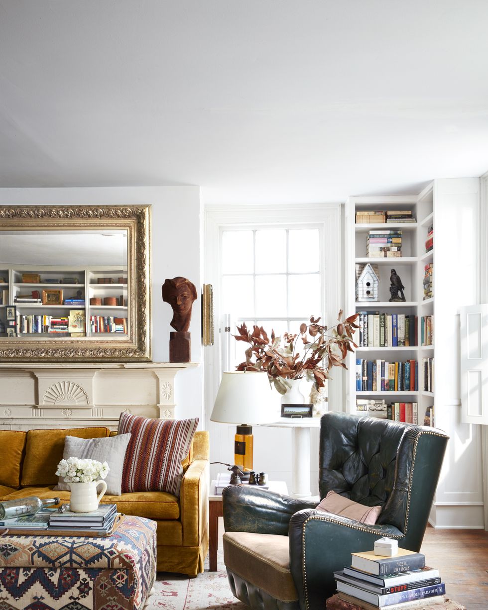 a living room with bookshelves in the corner