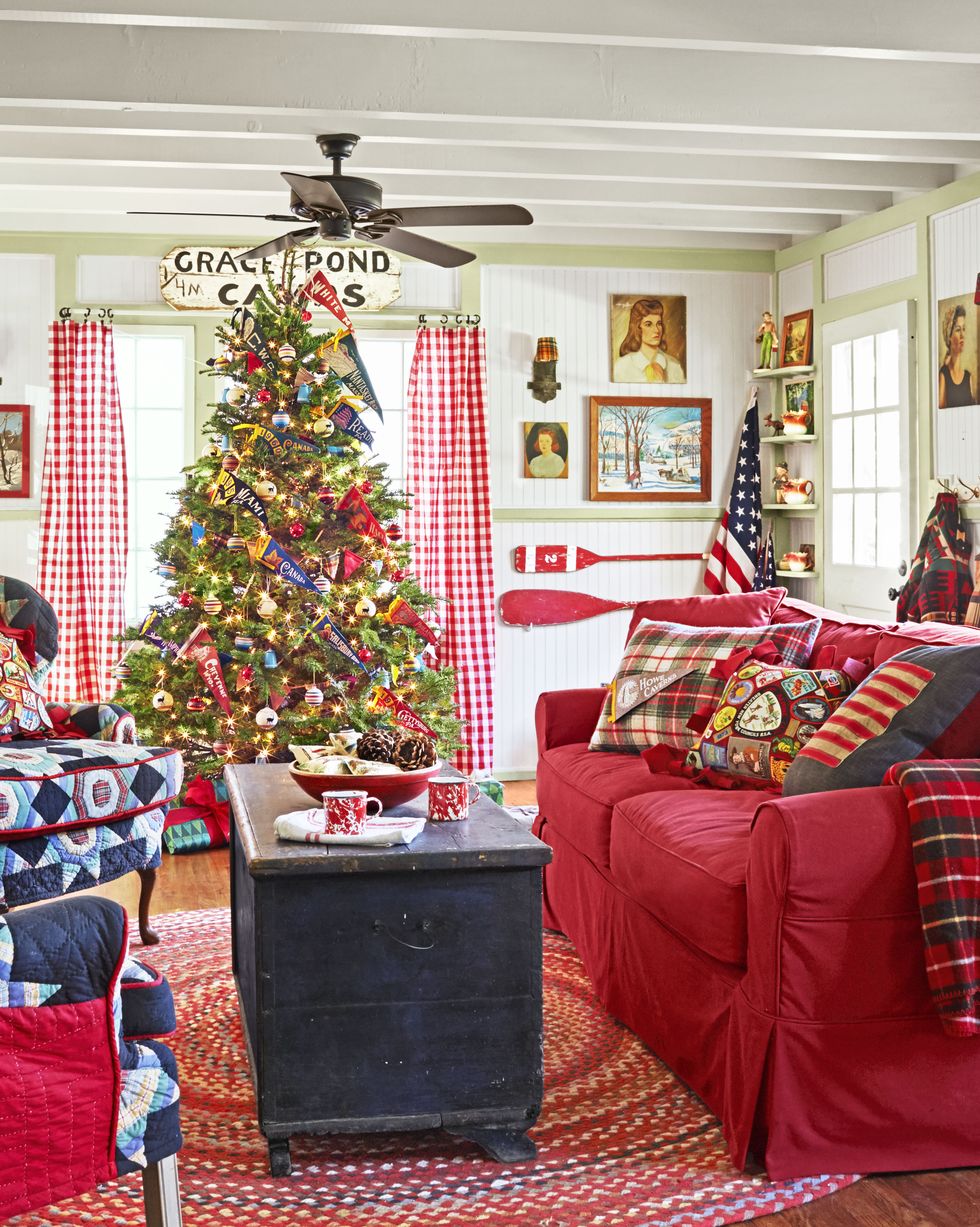 camp style christams tree with felt pennants in a bright, colorful living room