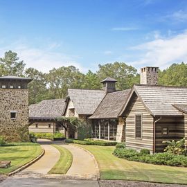 neutral timber frame house with shingled roof