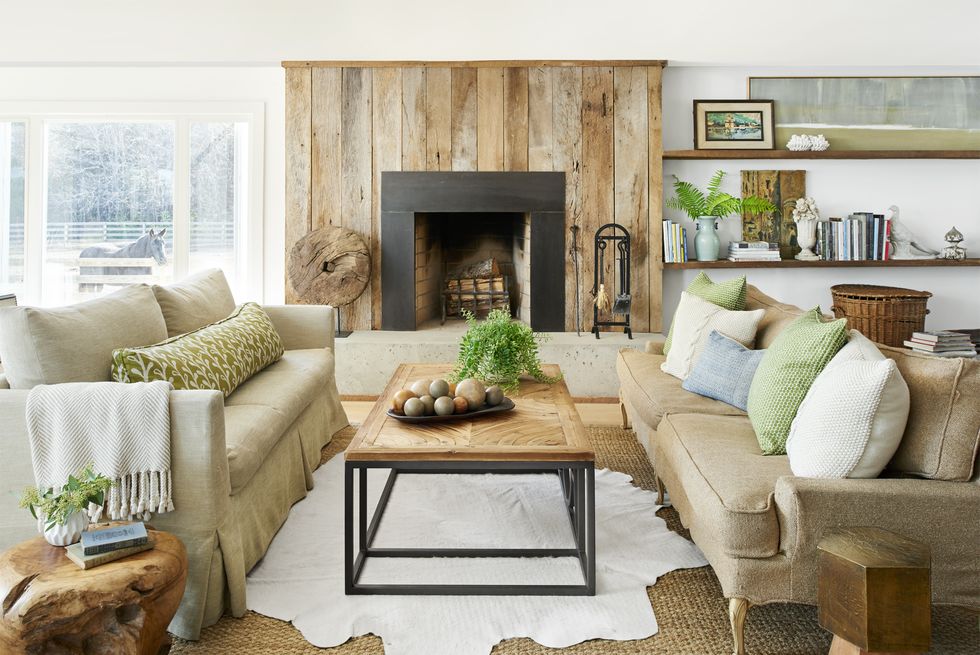 a living room with a fireplace wrapped in barnwood