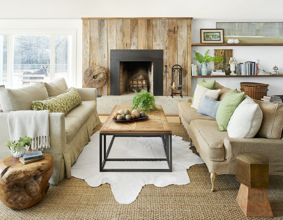 a living room with a fireplace wrapped in barnwood
