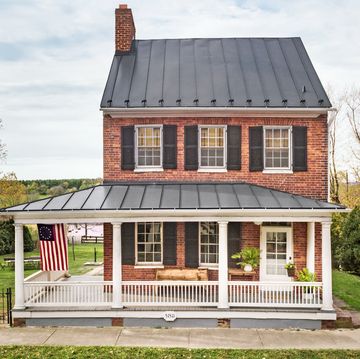 historic brick house with wraparound porch