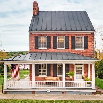 historic brick house with wraparound porch