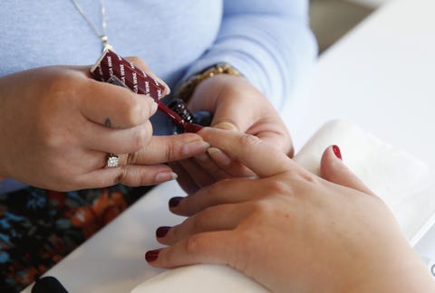 woman getting her nails painted