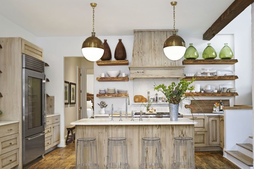 an all wood kitchen with clear barstools and white countertops