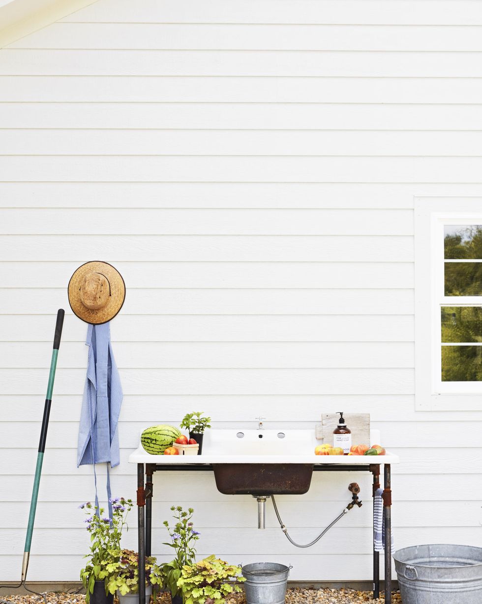 utility sink outside against a white wall