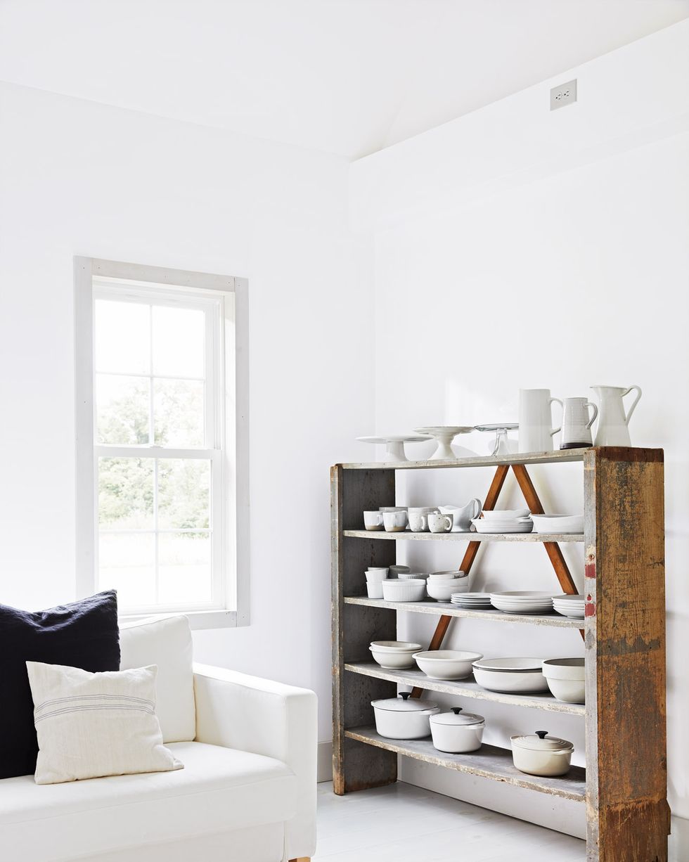 wood bookshelves holding whiteware and white kitchen items