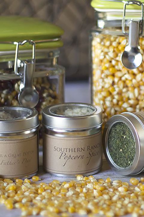 small jars of assorted popcorn seasonings and jar a popcorn kernels with a gift label reading for a great pop on father's day