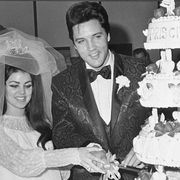 Elvis and Priscilla Presley cut their wedding cake