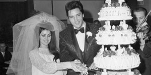 Elvis and Priscilla Presley cut their wedding cake