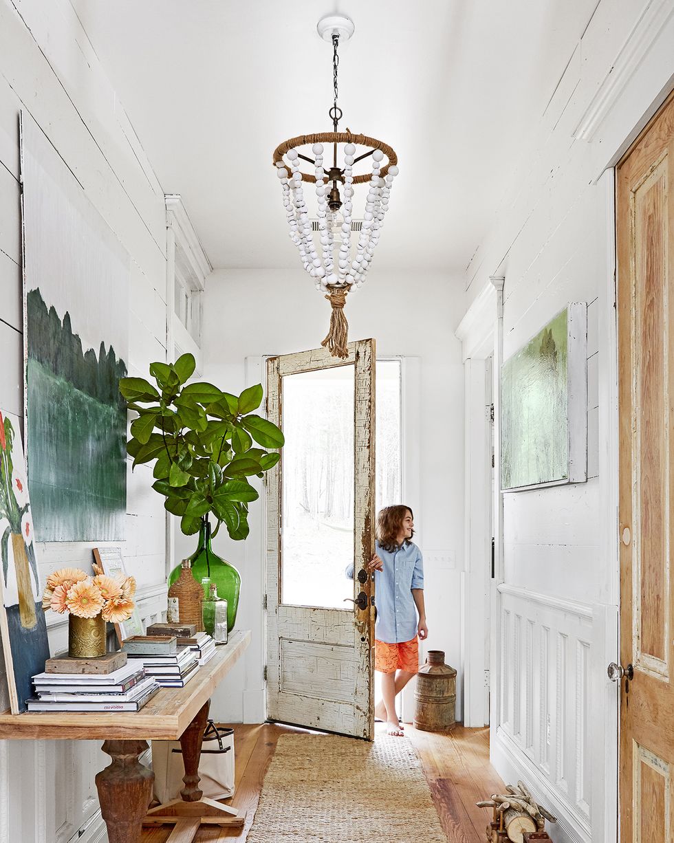 an old reclaimed door adds tons of character to a new build entryway