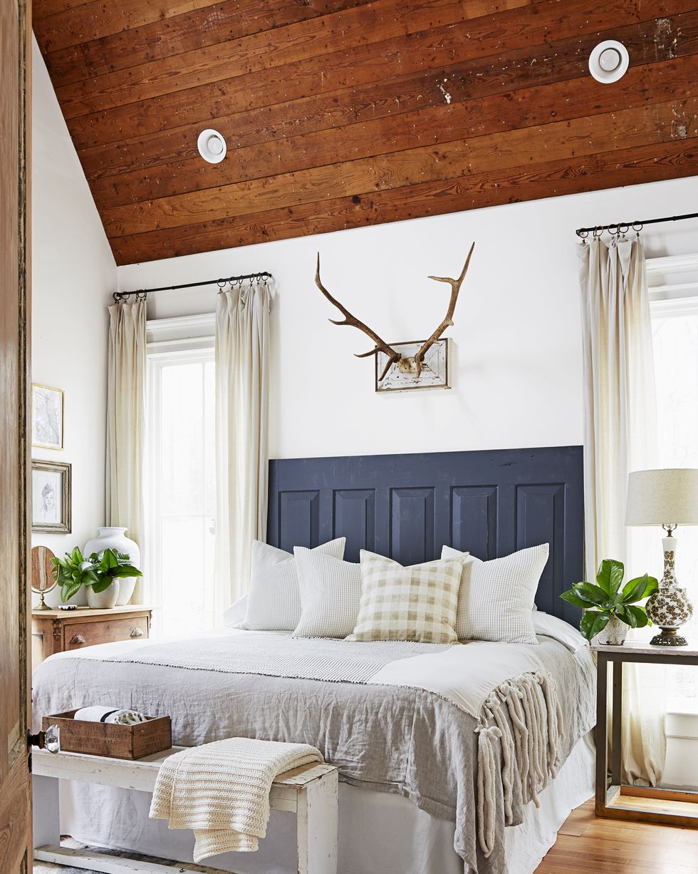 farmhouse bedroom with blue paneled headboard