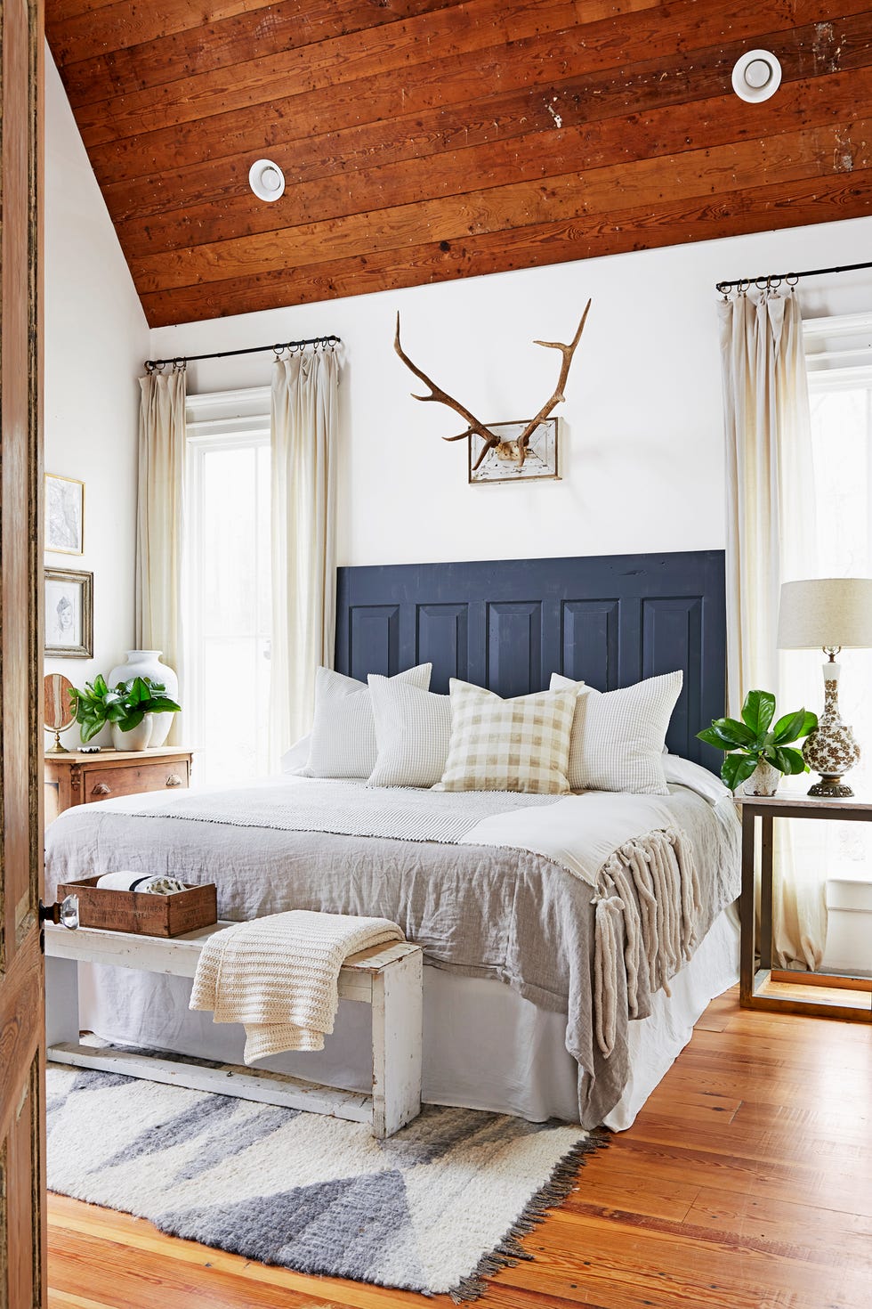 farmhouse bedroom with blue paneled headboard