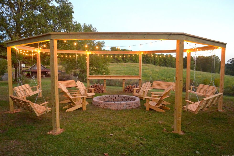 pergola with firepit in middle and adirondack chairs around