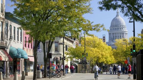 Tree, Town, City, Landmark, Yellow, Urban area, Human settlement, Pedestrian, Building, Public space, 