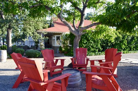Tree, Furniture, Chair, Outdoor furniture, Outdoor table, House, Shade, Home, Cottage, Armrest, 