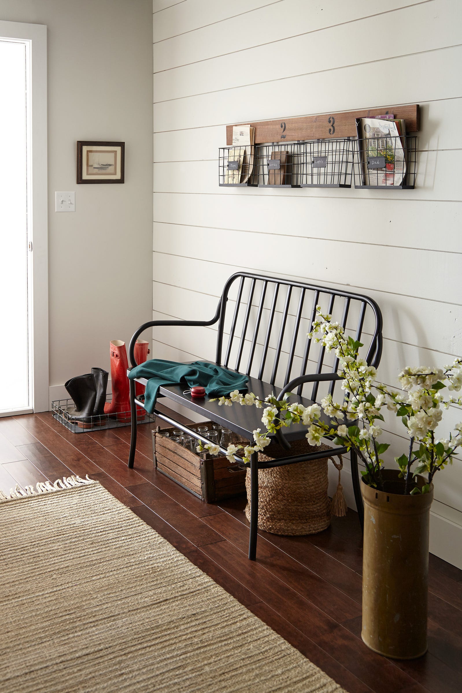 Farmhouse style entry with black bench, shiplap, rustic decor. Paint color is Kilz Shiplap.