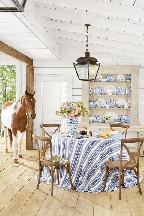 farmhouse style in a barn house dining room with blue and white accents and a horse
