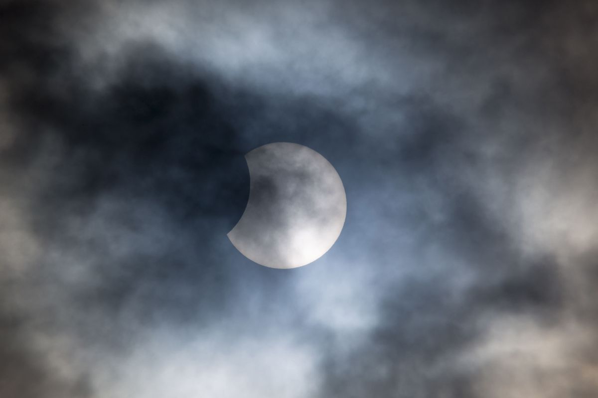 partial solar eclipse cloudy skies
