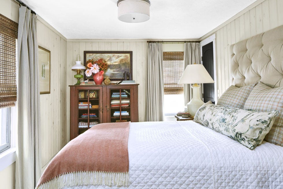 a bedroom with a big bed and wood bookcase