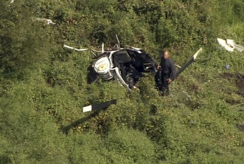 In this image from video provided by NBC10 Philadelphia, first responders are positioned near the wreckage of a helicopter in Lumberton, N.J., Friday, Sept. 8, 2017.
