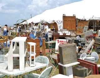 a variety of antique furniture at an outdoor market