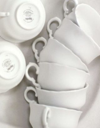 white teacups stacked on their sides