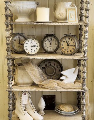cream colored antiques and clocks on a shelf