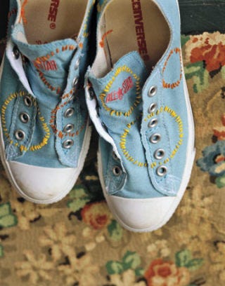blue converse sneakers with circles sewn on
