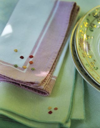 napkin with small polka dots folded next to a plate