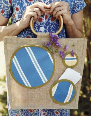 hands holding a purse with large striped polka dots