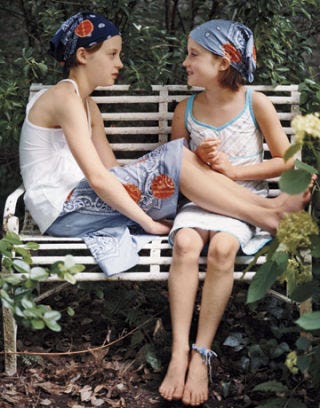 girls sitting on a bench wearing polka dot bandanas