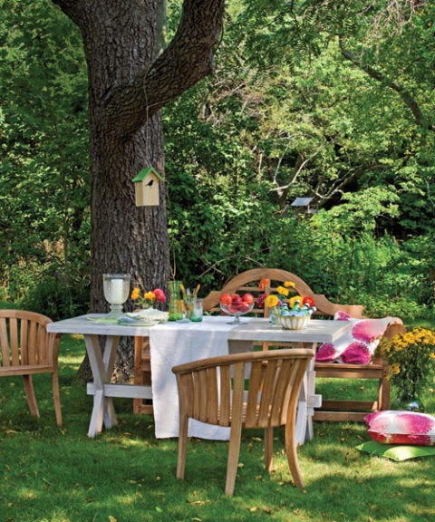 picnic table with wooden chairs and throw pillows