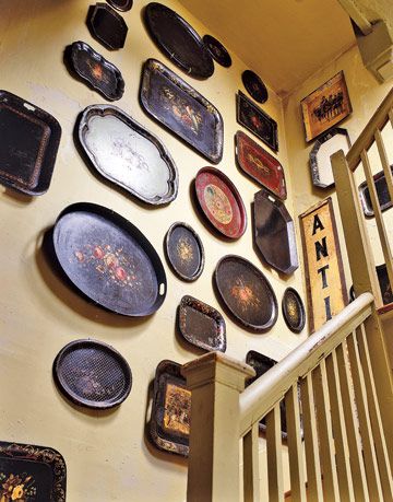 tole trays displayed above the stairs