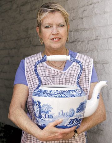 woman holding large spode watering pitcher