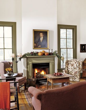 white living room with green trim windows and fireplace