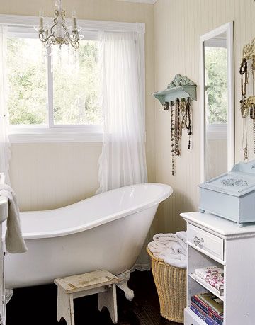 white slipper tub and chandelier