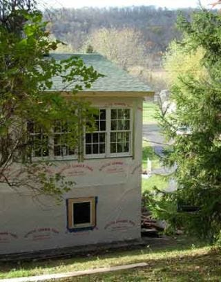 exterior view of house with green shingles on roof