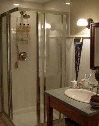 bathroom with sink and focal corner shower enclosure