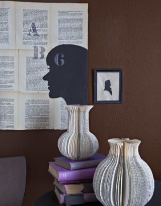 two paper vases made from books and a book page wall hanging with profile