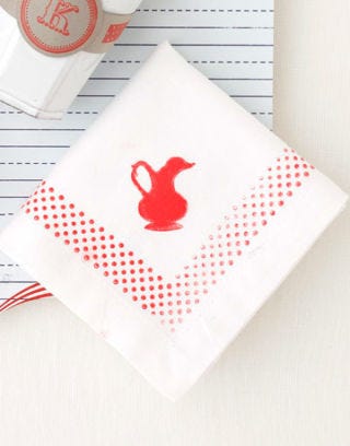 white napkin red border pitcher